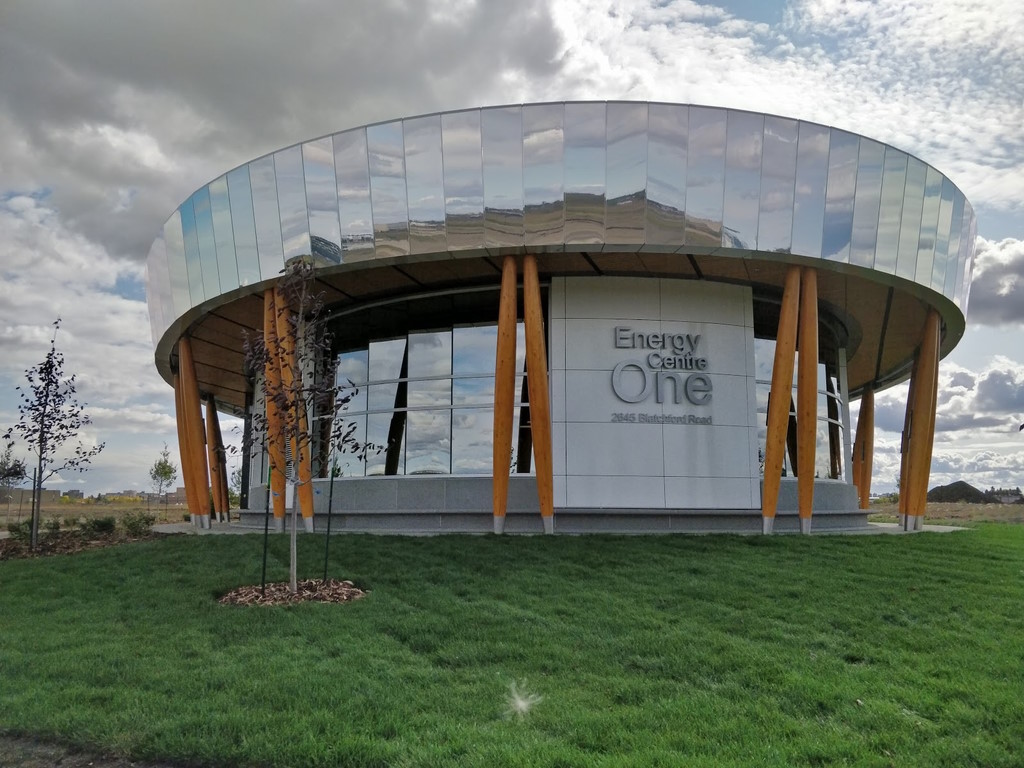 The round and mirrored Energy Centre One building in Blatchford surrounded by green grass