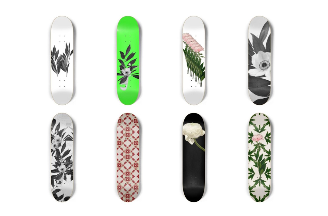 Eight colourful skateboards against a white background