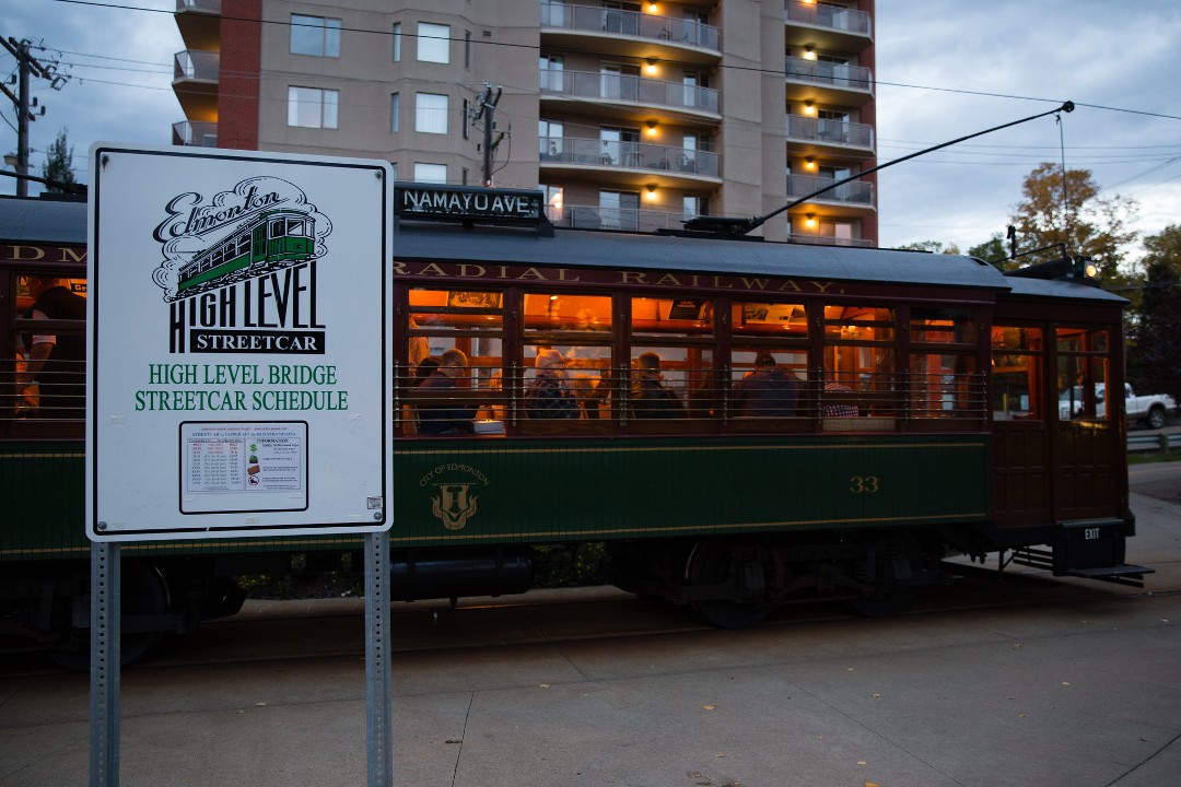 The Namayo Avenue High Level Streetcar behind a sign showing its schedule