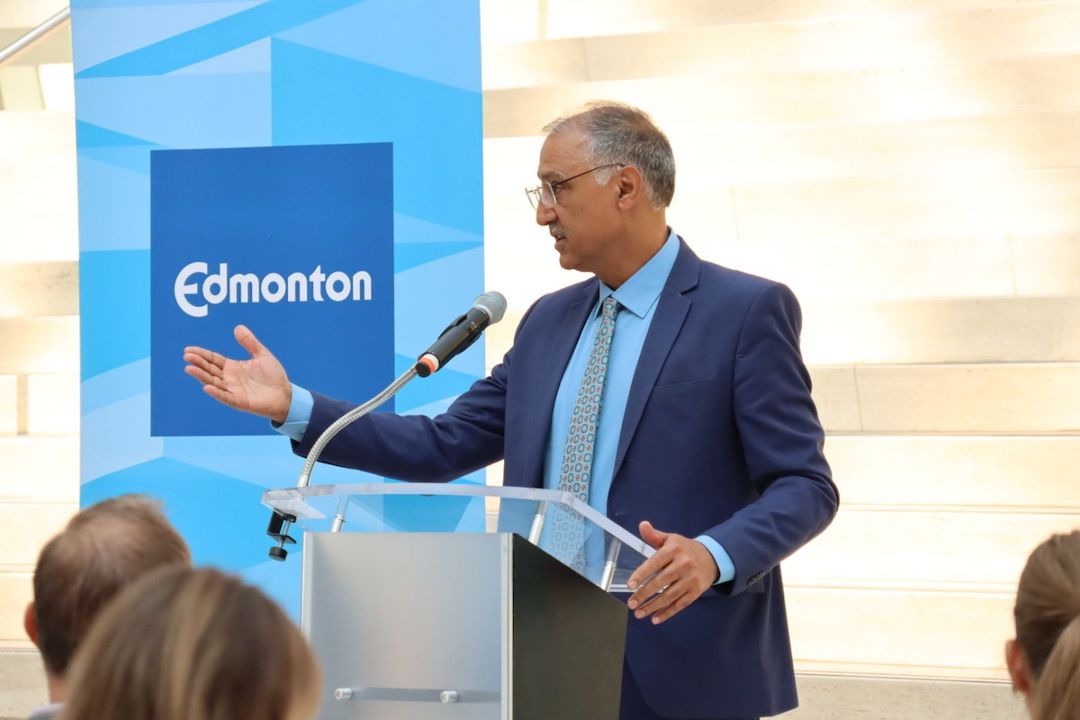 Mayor Amarjeet Sohi addresses a seated audience inside City Hall.