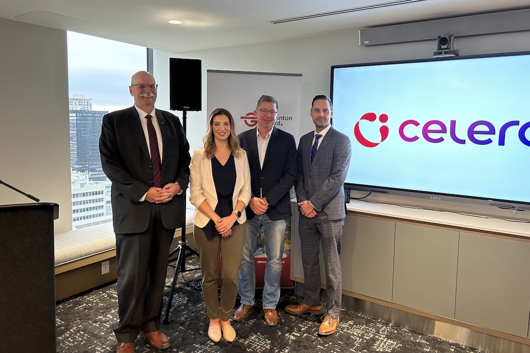 Four people stand in front of an Edmonton Global banner, beside Celero's logo on a screen