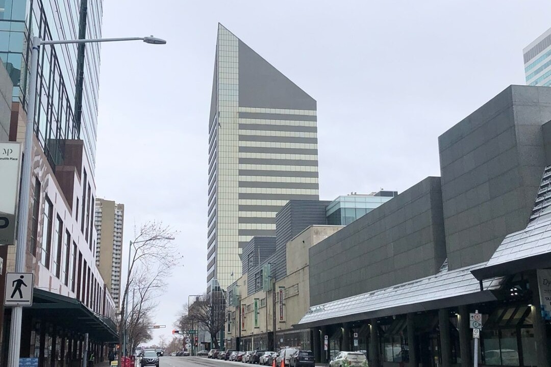 A pointy-topped, 23-storey tower made of glass and steel in downtown Edmonton.