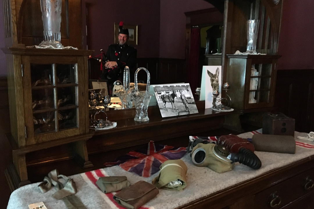 A table displaying Great War artifacts, including a Union Jack flag and a gas mask
