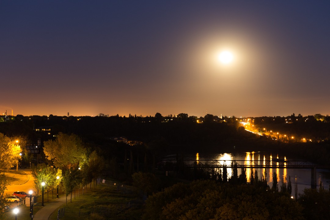 The harvest moon over the North Saskatchewan River on an autumn night