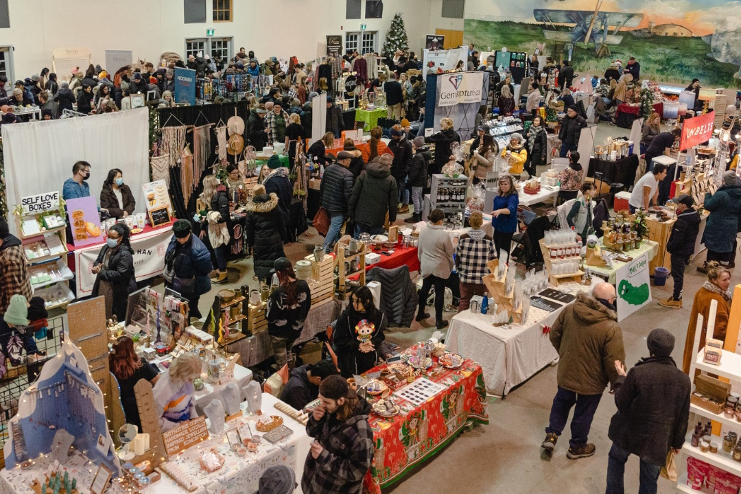 A market with booths set up for vendors to sell items.