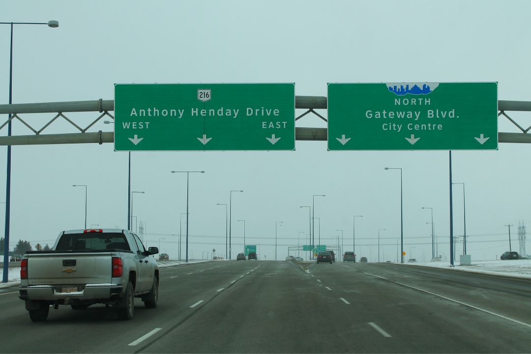 Vehicles travel along Anthony Henday Drive under a bleak sky.