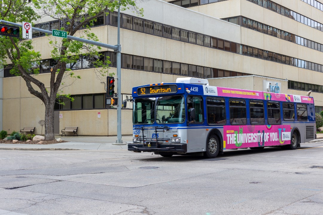 The number 52 bus drives on 107 Street in downtown Edmonton.