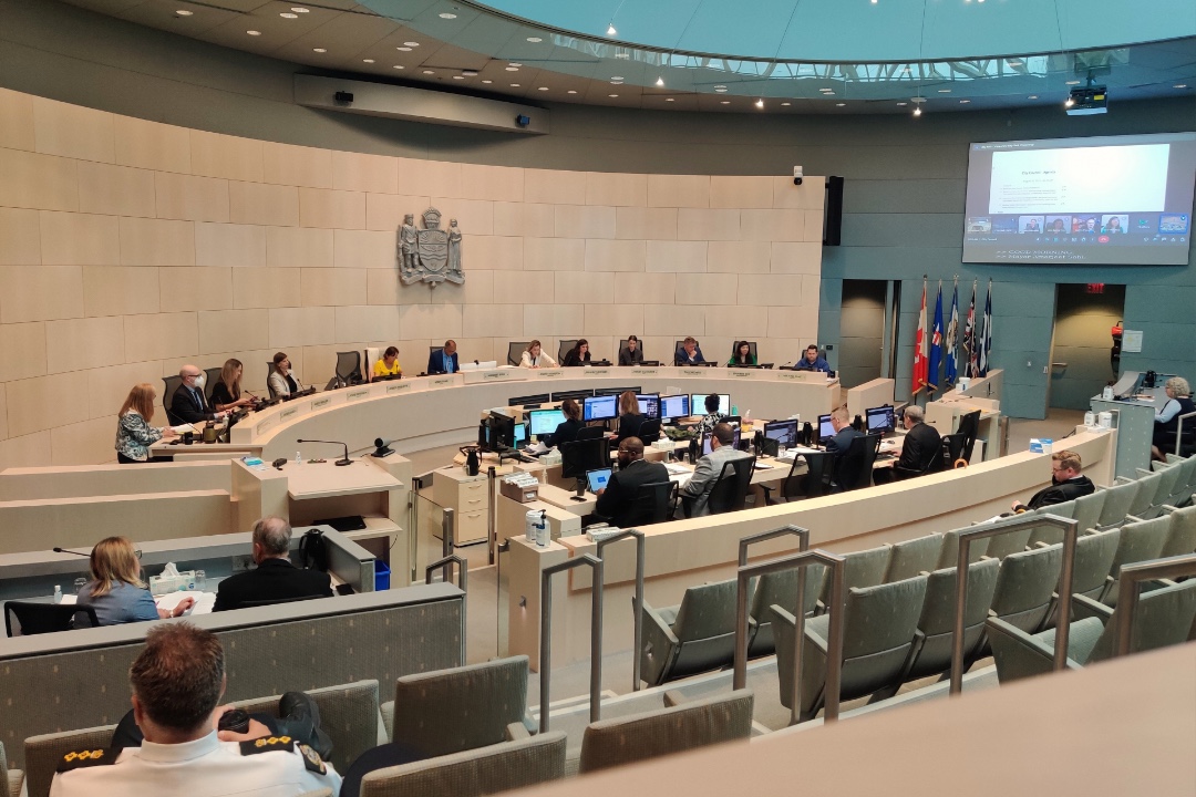 City Councillors sit in a semicircle at the front of the council chambers in Edmonton.