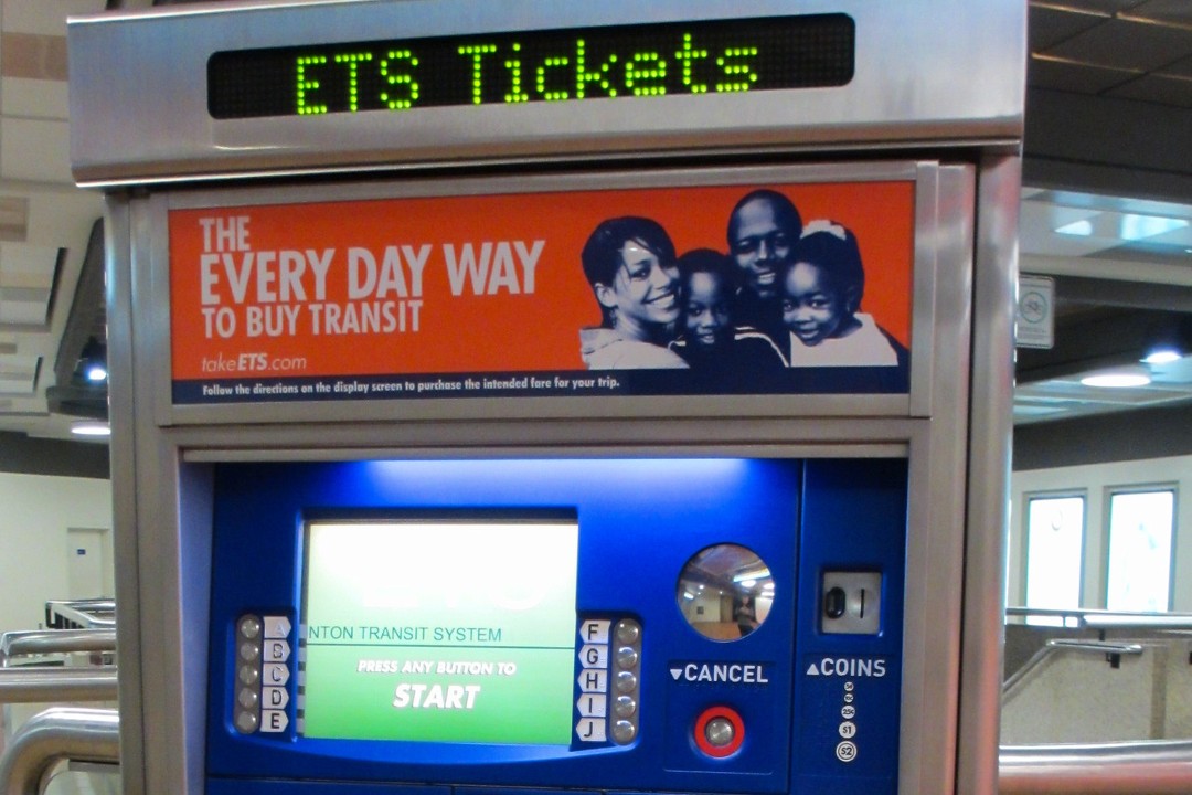 A picture of an Edmonton Transit Service ticket machine. The screen says "Press any button to START".