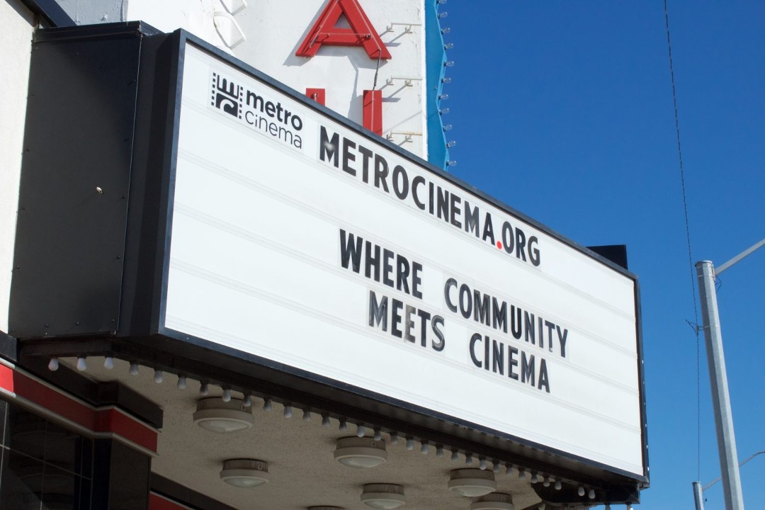 A marquee for Metro Cinema at the Garneau Theatre reads, "Where Community Meets Cinema."