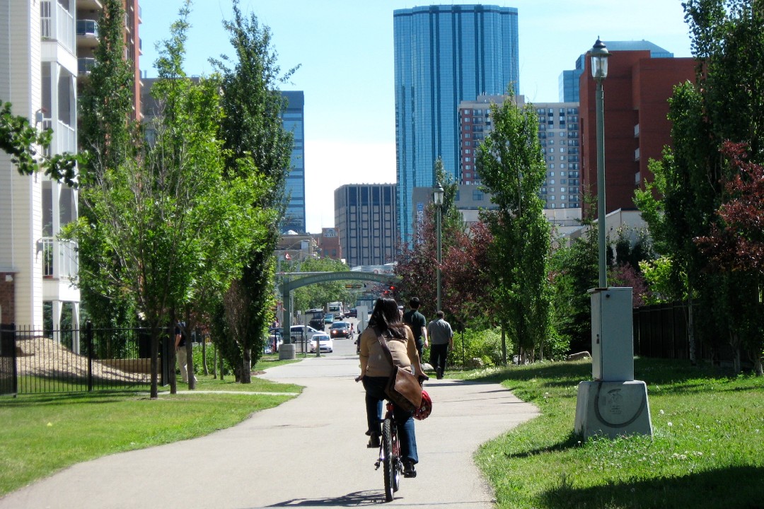 A person rides a bike on a shared-use path in Edmonton.