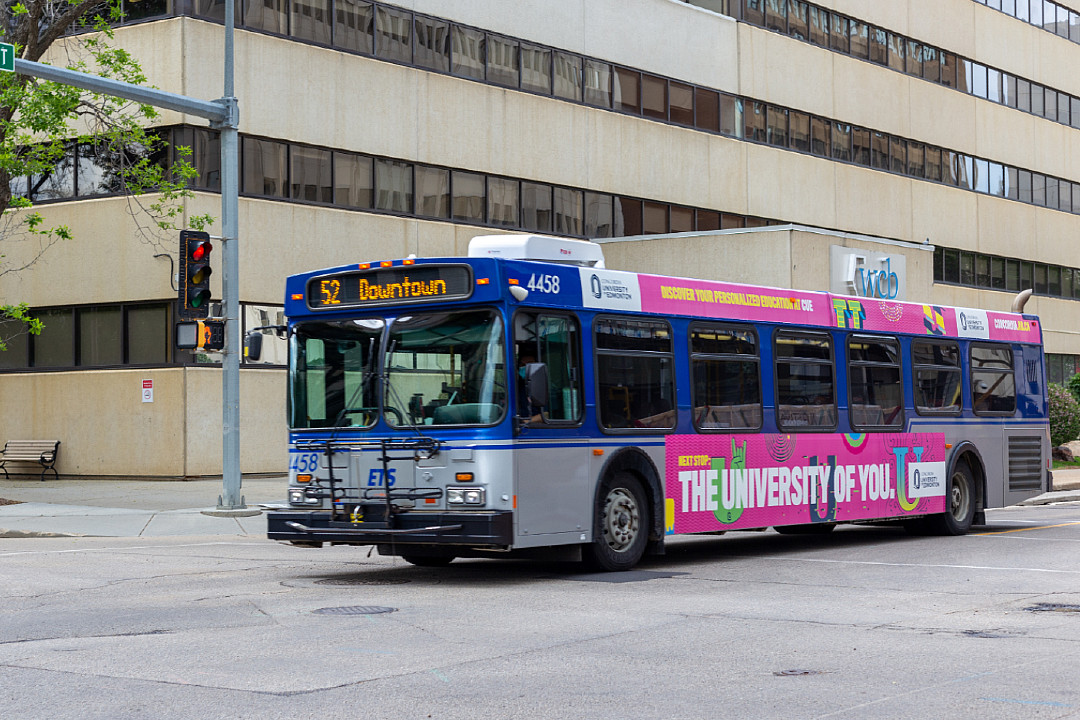 Edmonton Transit Service bus #52 passing through an intersection on a downtown street