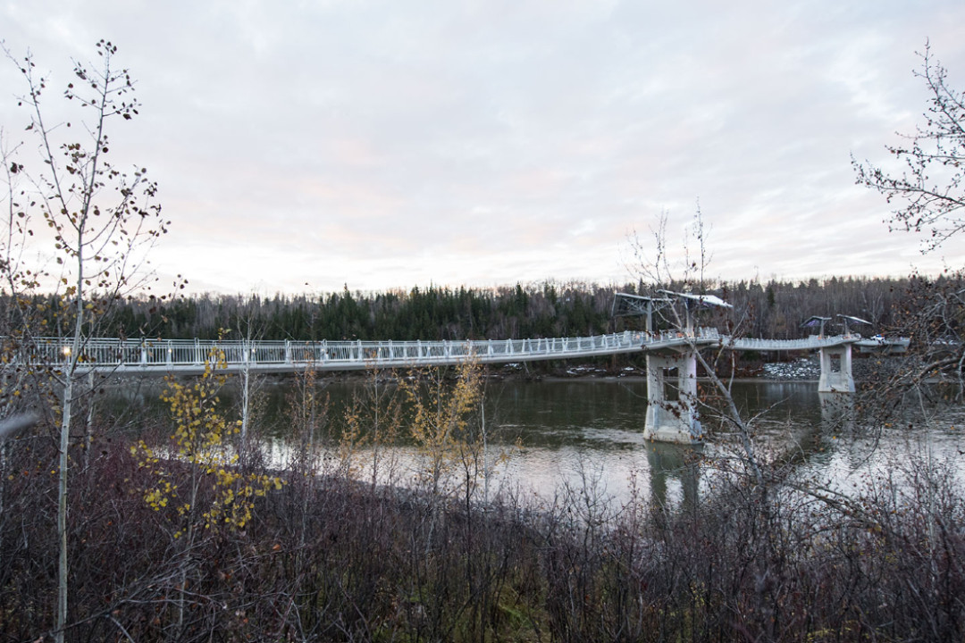 A footbridge across the North Saskatchewan River on an overcast day