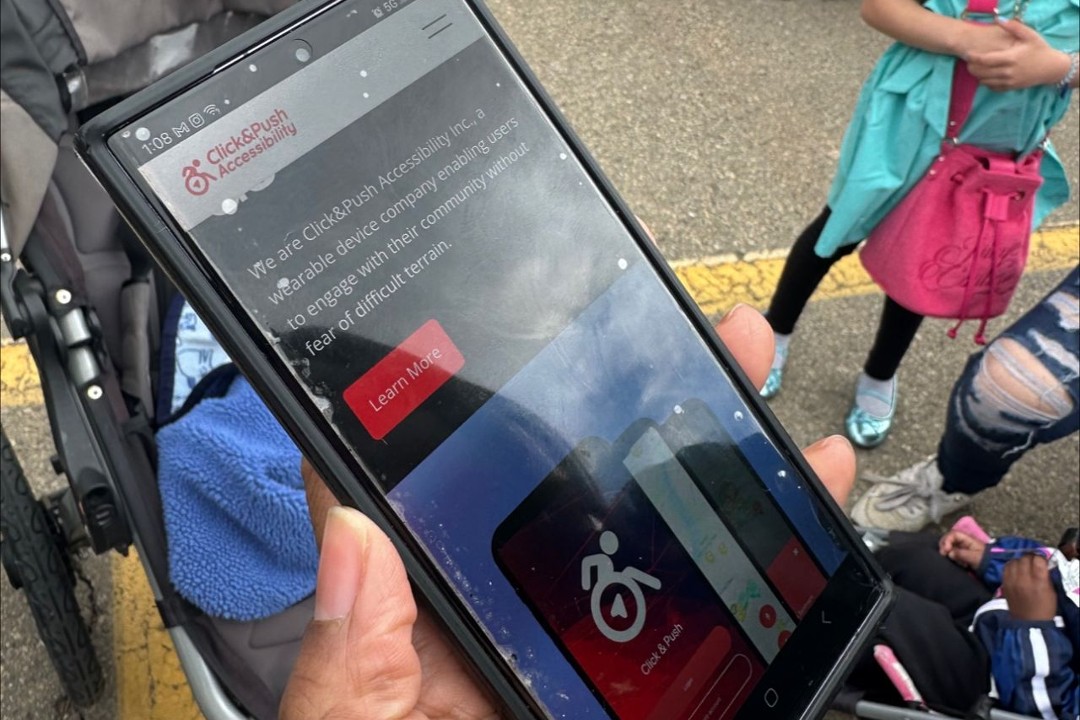 A person holds a phone displaying The ATLAS app.