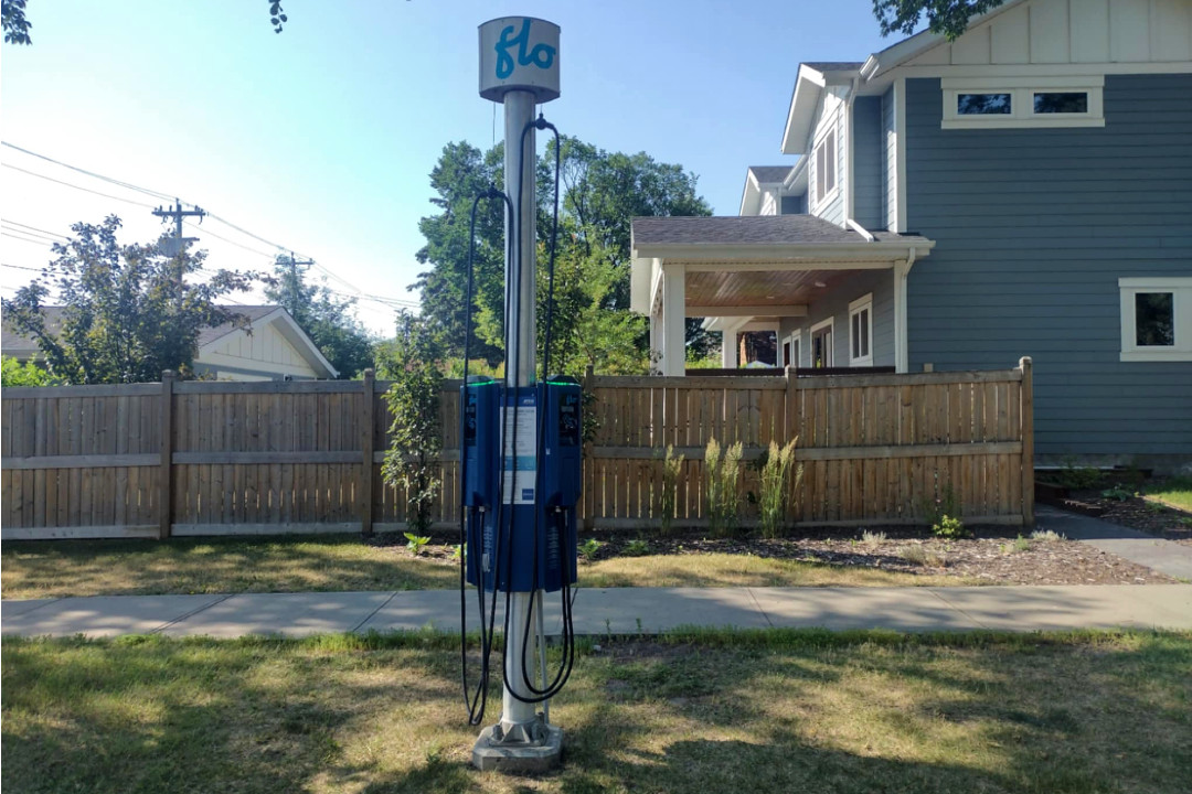 A single electric vehicle charging station installed on the boulevard in a residential area