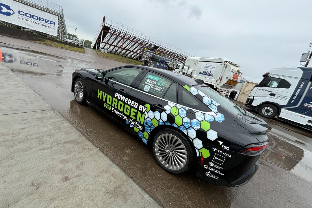 A photo of a black car with a sticker that reads, "Powered by Hydrogen"