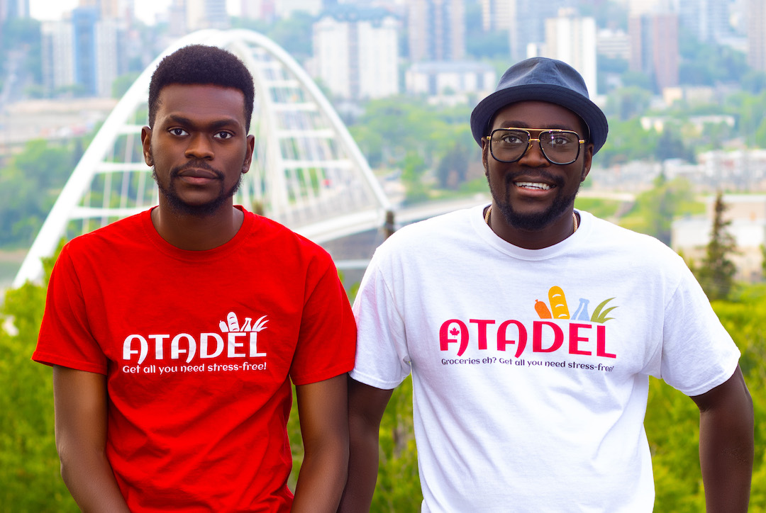 Two people stand at the edge of Edmonton's River Valley wearing shirts that read "Atadel."