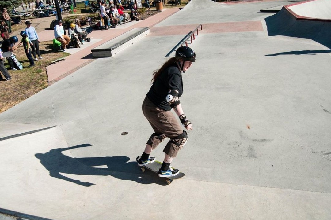 A skater carves at a skate park.