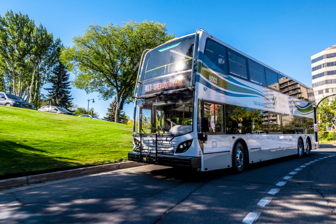 A Strathcona County Transit double-decker bus on the road on summer day