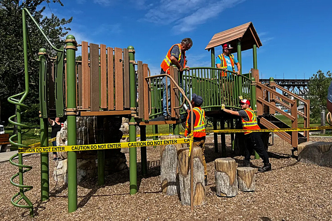 City of Edmonton crew members in reflective vests working on a playground structure