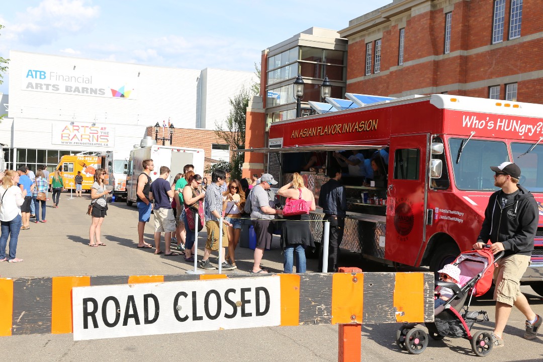 People lined up for a food truck outside the ATB Financial Arts Barn.