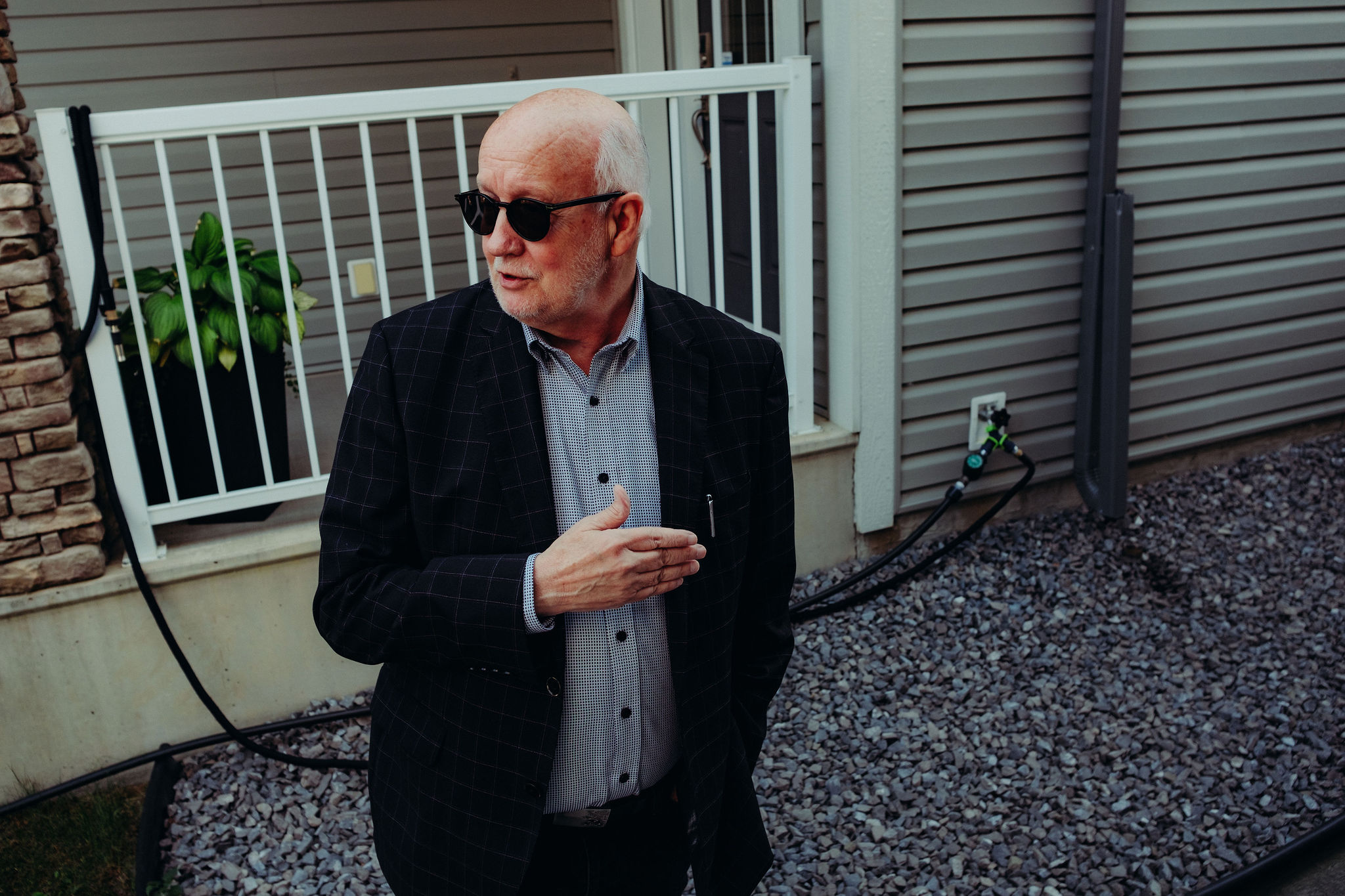 A man gestures with his hands looking away from the camera.