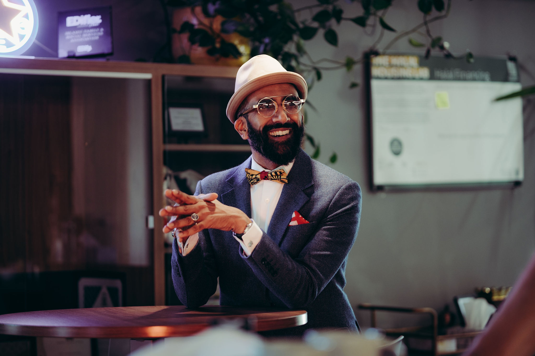 A man in a suit smiles.