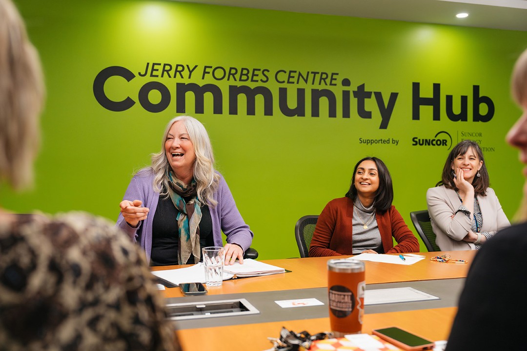 A group of people in a room. Behind them, on a wall, the words "Jerry Forbes Centre" are written in large text.