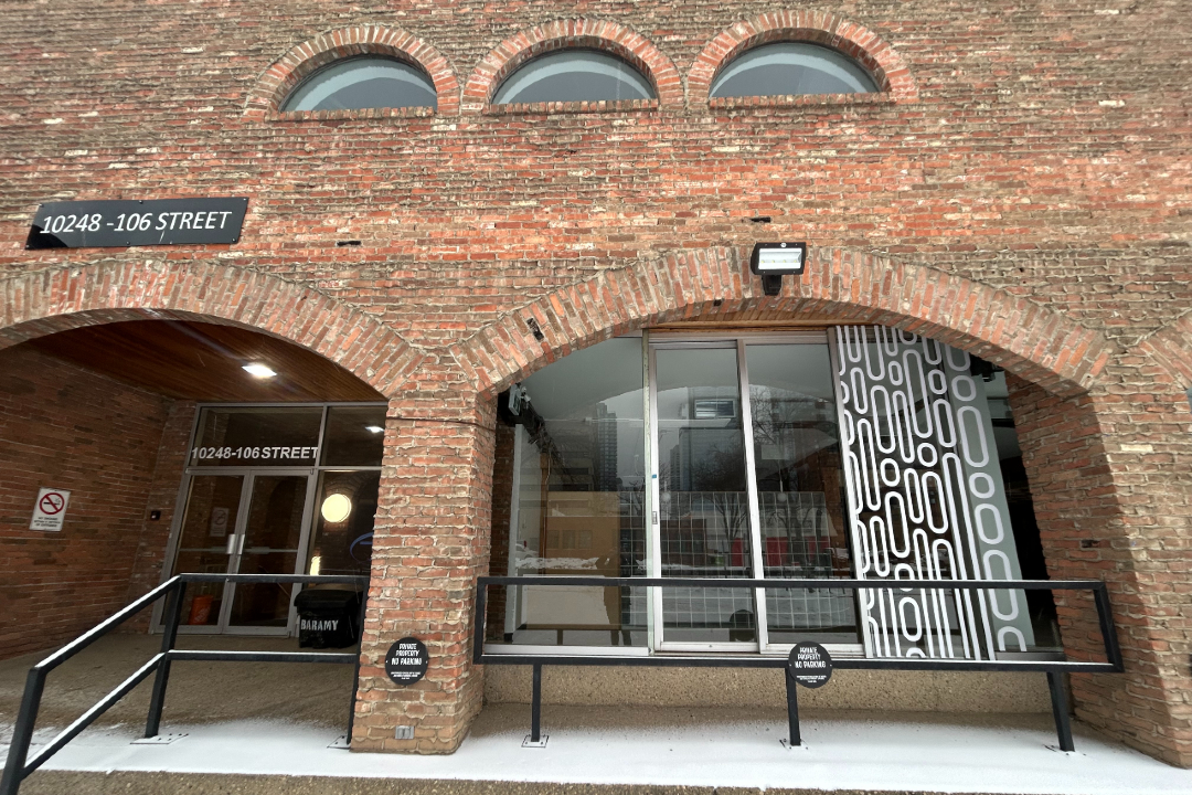 The outside of brick commercial building on a snowy day.