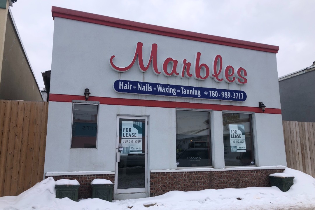 A photo of a building with a sign that reads "Marbles".