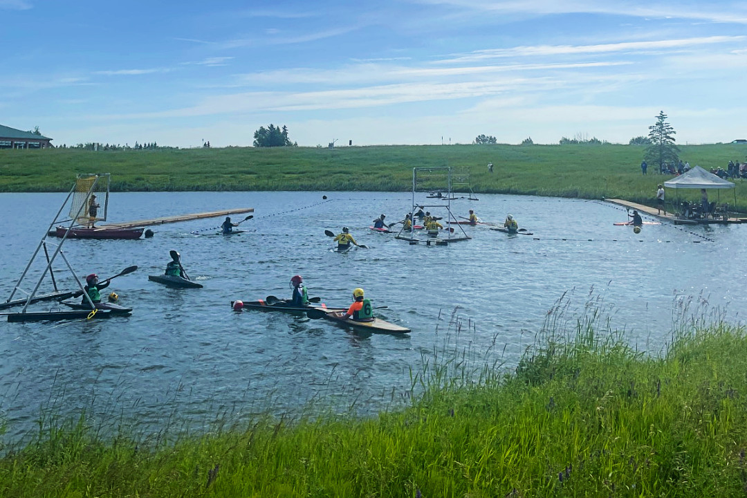 Group of people kayaking in a body of water in a park