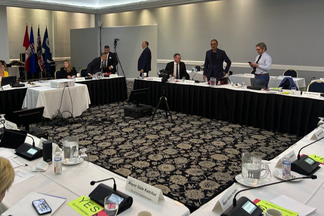 Regional mayors gathered around a board room.