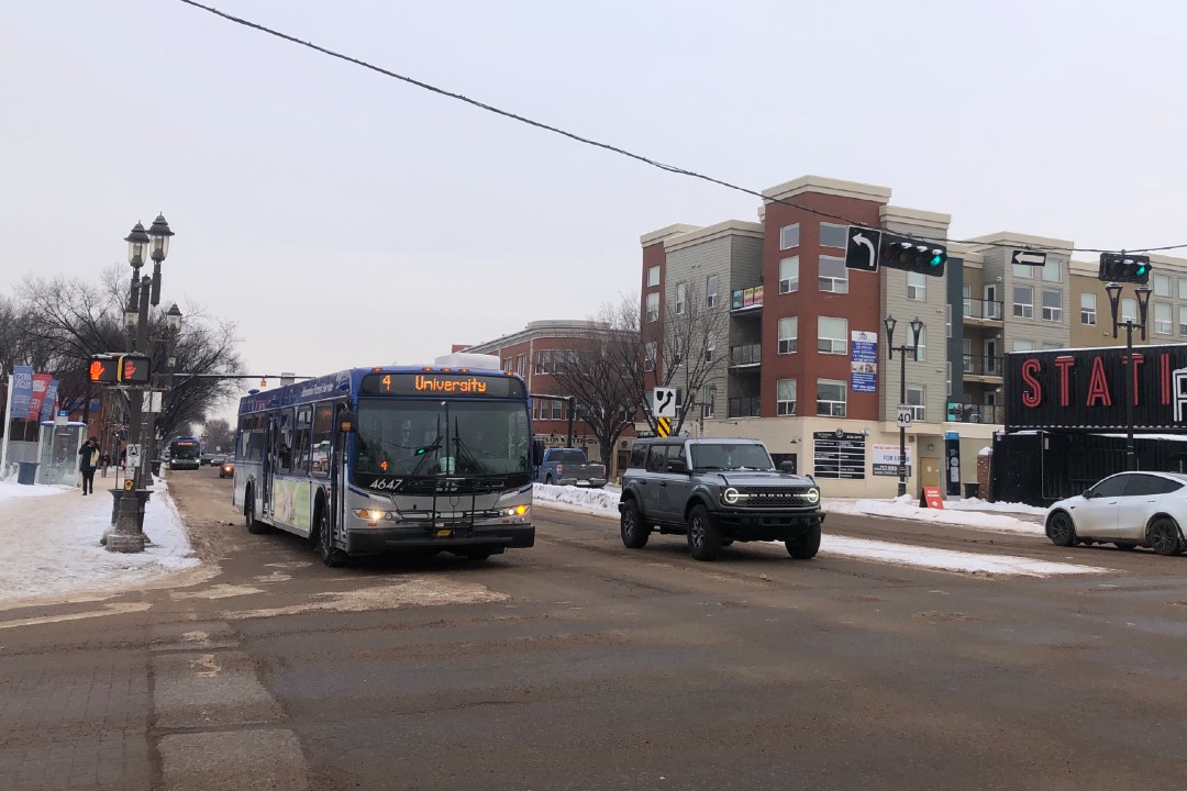 A bus drives west on Whyte Avenue.