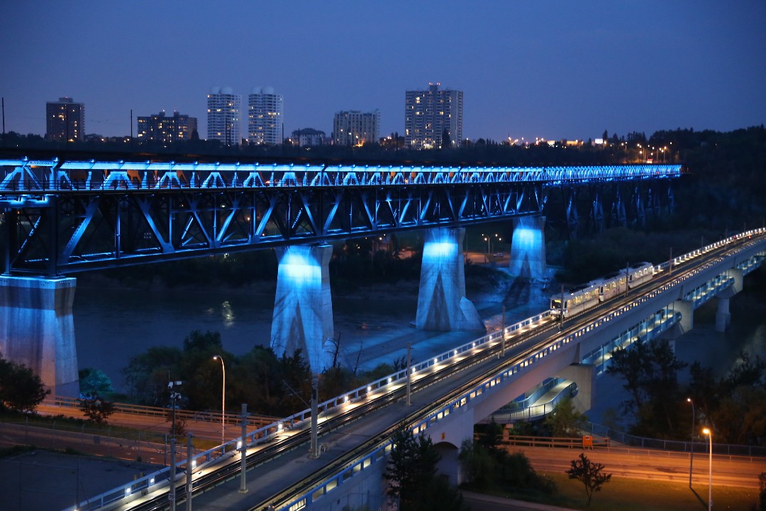 Edmonton's High Level Bridge lit blue at night.