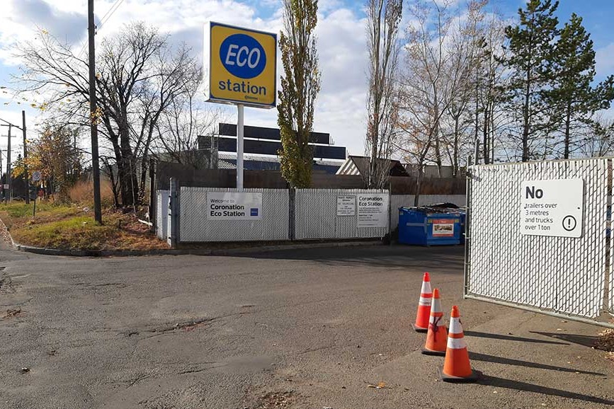 A white fence surrounds waste drop-off bins and a sign for the Coronation Eco Station.