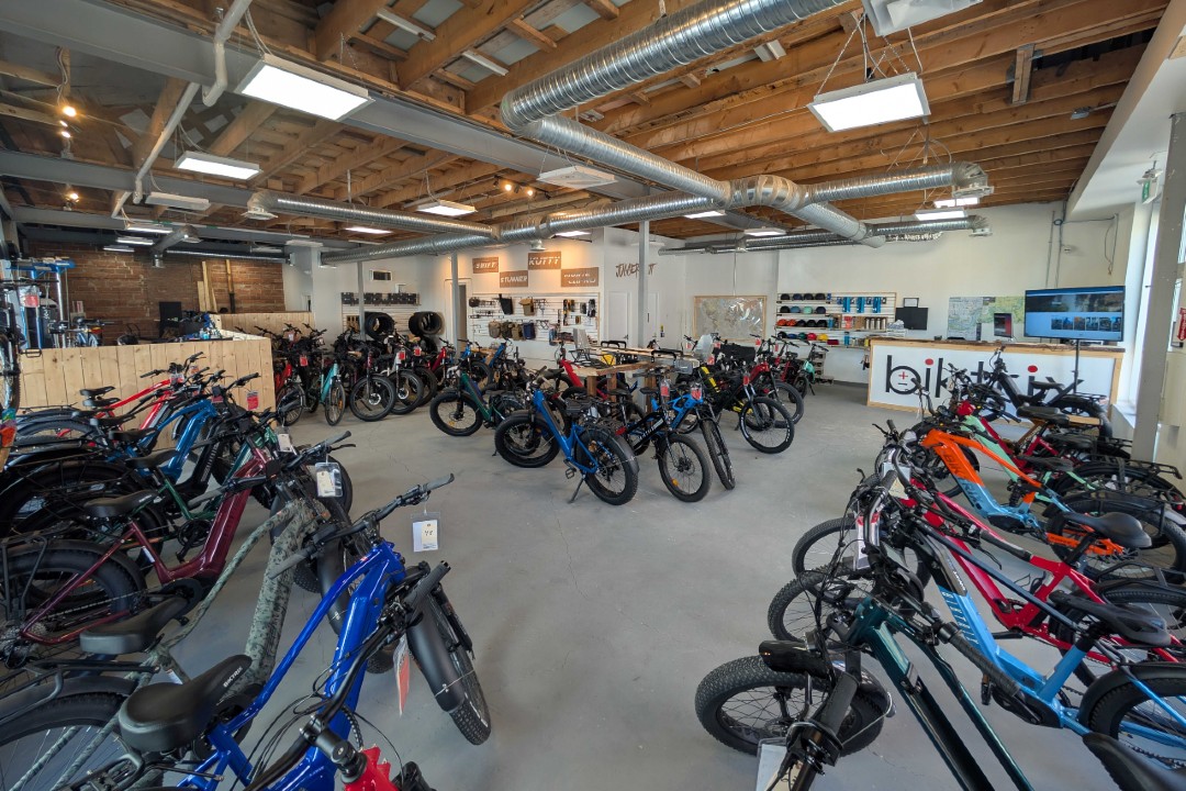 Biktrix sees selling e-bikes downtown as a core belief A shop floor full of dozens of e-bikes.