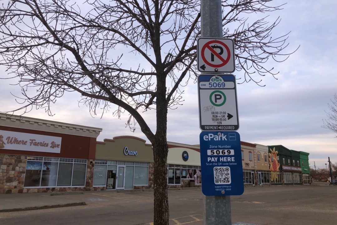 Noted: Free parking, app fixes, austerity Parking signs mounted to a pole.