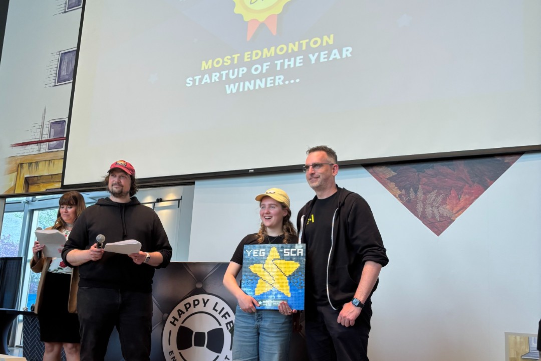 Artificial Agency wins at YEG Startup Community Awards People stand on stage accepting an award,