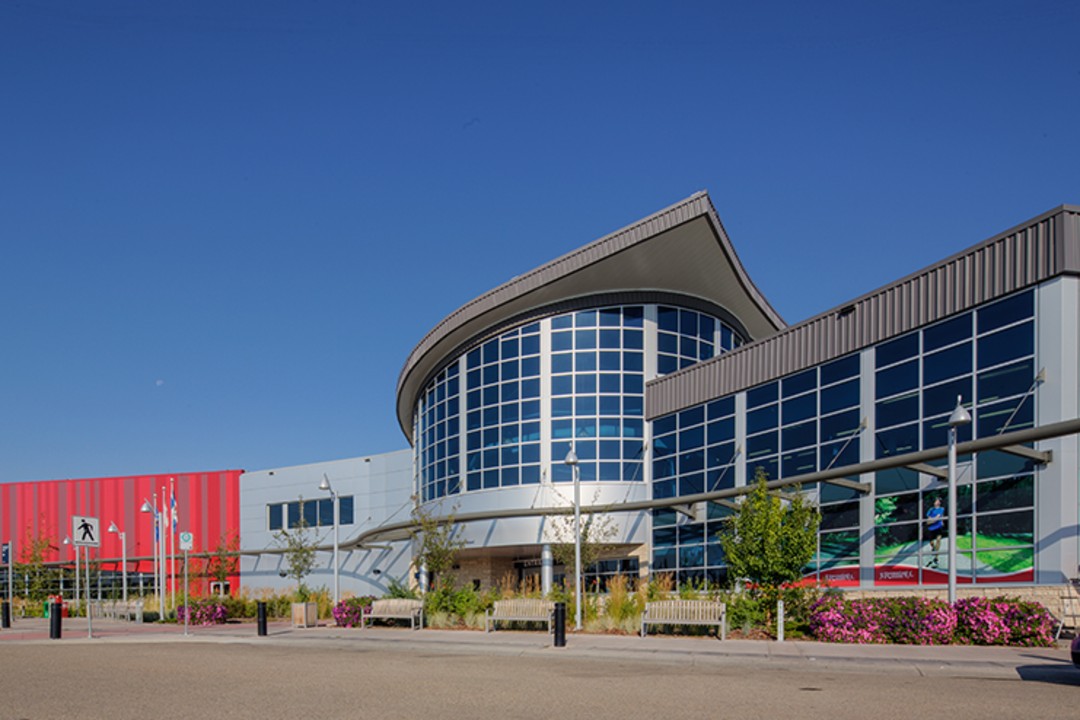 Edmonton eyes selling naming rights for 29 public facilities A silver building with reflective windows under a blue sky.