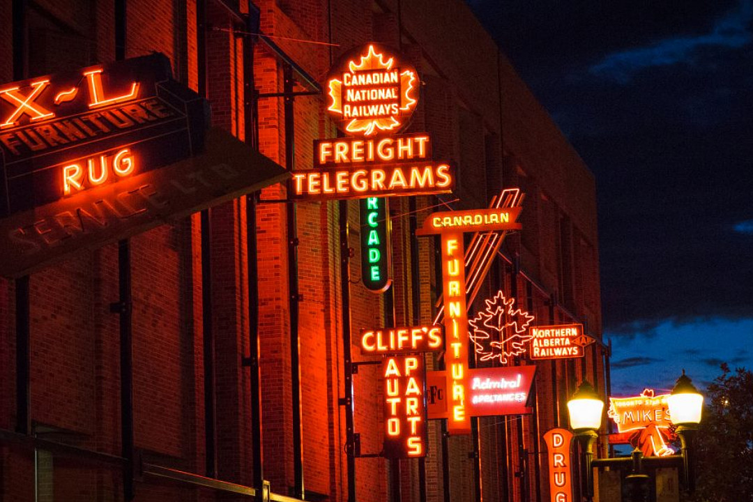Calls for public engagement: Waste services, heritage places, business census Neon signs from assorted businesses, displayed on a brick wall at night