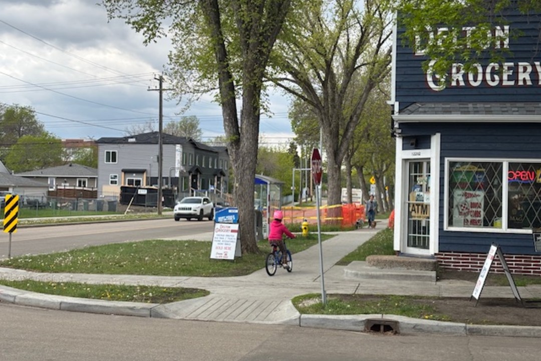Debate grows as Edmonton Plans 23 km of new active transportation infrastructure for 2025 A child rides a bike near the Delton Grocery in north Edmonton.
