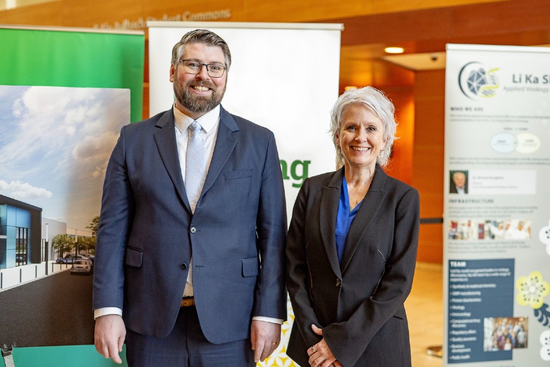 As Edmonton biotech industry booms, Launa Aspeslet steps up to guide further success Two smiling people in business attire pose for a photo.