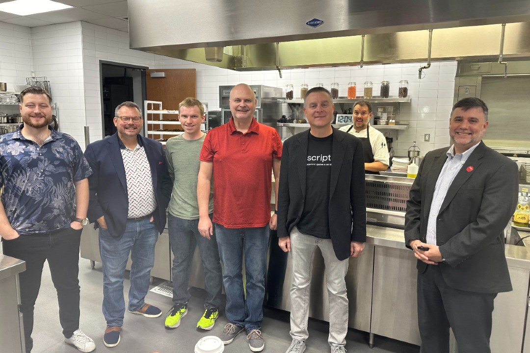 Scription plots growth in fast-food maintenance after US$7.85M investment Six people pose for a photo in a kitchen.