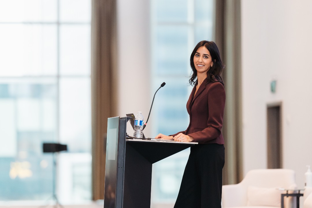 As McBryan announces EDBA exit, she sketches out a hopeful future for downtown A smiling woman in business attire looks over her shoulder from behind a podium.