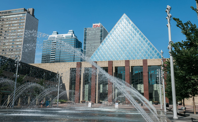 Happenings: July 3, 2025 Water spraying into the pool with Edmonton City Hall in the background