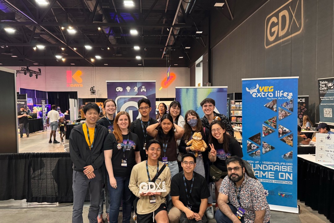 Baby Ghosts Alberta creates new accelerator to give marginalized developers a leg up A group of people wearing lanyards pose inside a convention hall. One holds a sign that says "GDX," while signage for KDays and GDX are in the background.