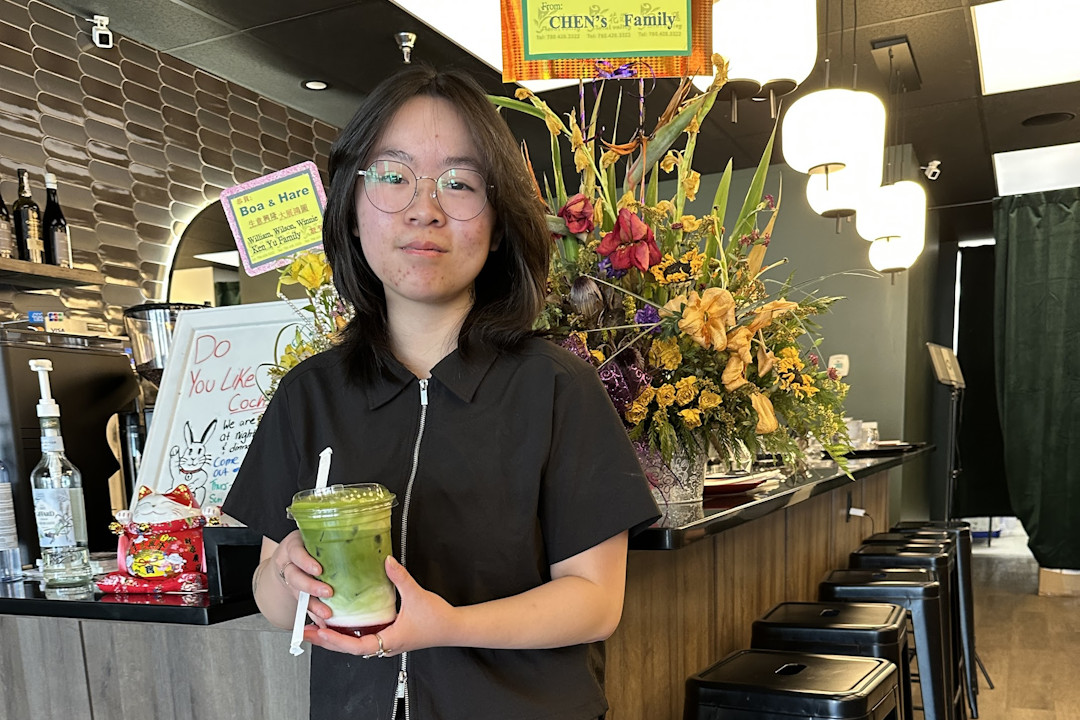 Kelly Yu of Boa and Hare holding a matcha latte