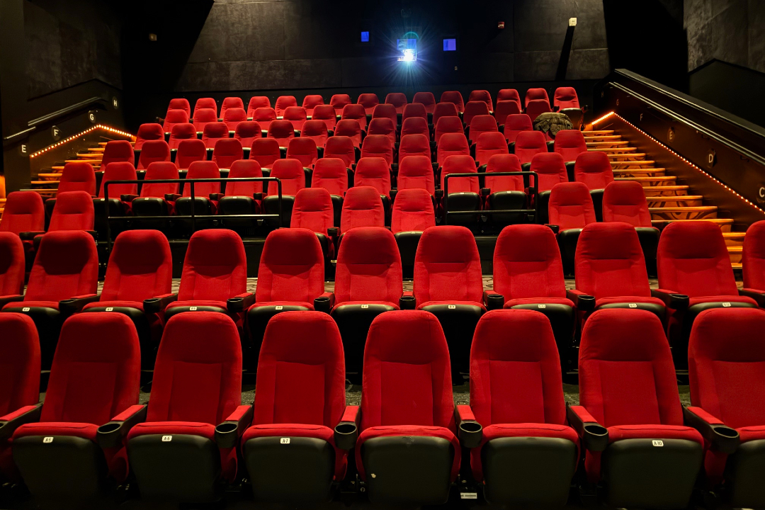 A cinema full of empty red seats.