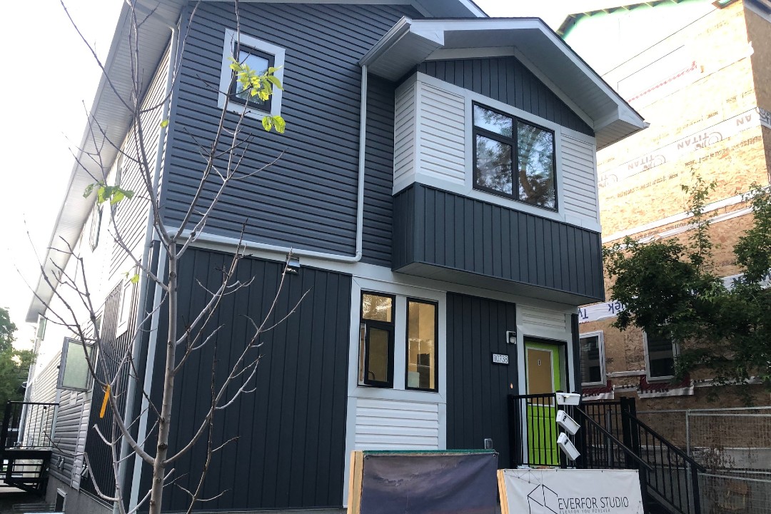 A grey and white multi-unit infill development.