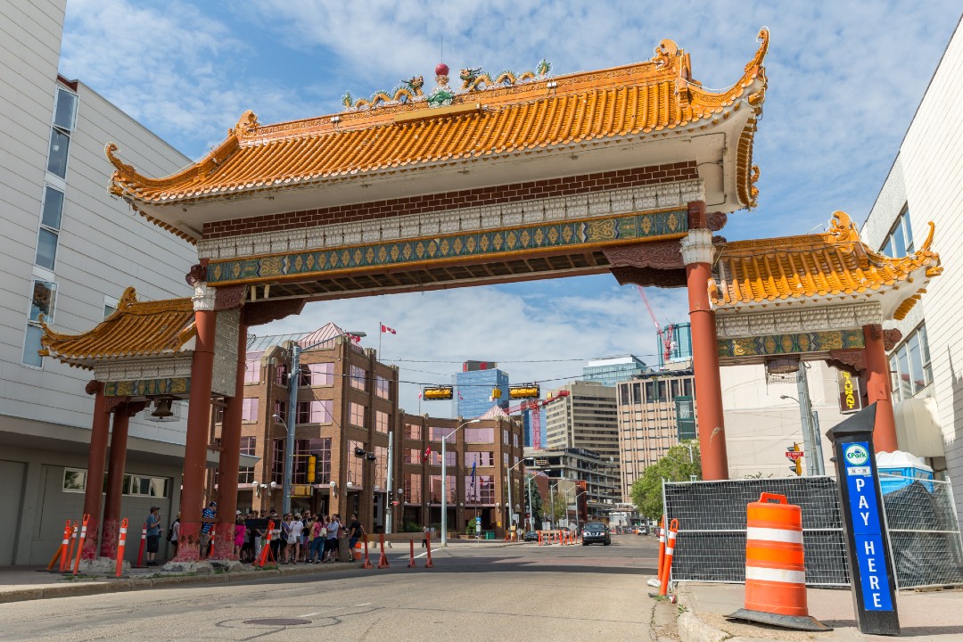 A large arch structure spans a street in Edmonton's Chinatown.